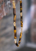 detail halsketting met tijgeroog en citrine